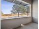 Charming balcony view featuring lush green trees and a serene neighborhood street at 485 Interlocken Blvd # 101, Broomfield, CO 80021