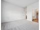 Spacious bedroom featuring neutral carpeting, white walls, and ample natural light at 485 Interlocken Blvd # 101, Broomfield, CO 80021
