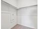 Walk-in closet with carpeted floors and metal shelving for storage at 485 Interlocken Blvd # 101, Broomfield, CO 80021