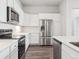Beautiful kitchen with stainless steel appliances, white cabinetry, and wood floors at 485 Interlocken Blvd # 101, Broomfield, CO 80021