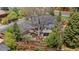 Aerial view of the property showcasing the house, patio, landscaping, and mature trees at 5471 S Sherman St, Littleton, CO 80121