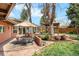 Inviting backyard with patio, seating, mature trees, and a gazebo at 5471 S Sherman St, Littleton, CO 80121