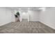 A finished basement with neutral carpeting, white walls, recessed lighting, and an open doorway to another room at 5471 S Sherman St, Littleton, CO 80121
