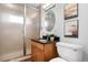 Updated bathroom featuring a glass door shower, granite vanity, and modern fixtures at 5471 S Sherman St, Littleton, CO 80121