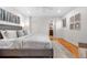 Cozy bedroom with hardwood floors and a gray upholstered bed and a view into a bathroom at 5471 S Sherman St, Littleton, CO 80121