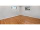 Well-lit empty room featuring hardwood floors and two windows at 5471 S Sherman St, Littleton, CO 80121