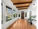 Bright entryway featuring wood floors, a wood-beamed ceiling, and large windows offering an abundance of natural light at 5471 S Sherman St, Littleton, CO 80121