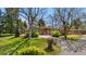 Charming brick ranch home with mature trees, lush landscaping, and circular driveway at 5471 S Sherman St, Littleton, CO 80121