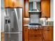 The kitchen has stainless steel appliances, a sleek gas range, and stylish wood cabinetry at 5471 S Sherman St, Littleton, CO 80121