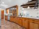 Charming kitchen has wood cabinets, stainless appliances, granite countertops, and a skylight for natural light at 5471 S Sherman St, Littleton, CO 80121