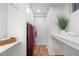 A laundry room features tile flooring, shelving, and a red washer and dryer at 5471 S Sherman St, Littleton, CO 80121