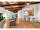 Bright, open-concept living room boasts hardwood floors, modern furniture, and a seamless flow to the kitchen and entryway at 5471 S Sherman St, Littleton, CO 80121