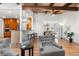 Open-concept living room features hardwood floors, stylish furniture, and open sight lines into the kitchen and dining room at 5471 S Sherman St, Littleton, CO 80121