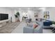 Staged basement living room with modern furniture, neutral carpet, and ample lighting at 5471 S Sherman St, Littleton, CO 80121