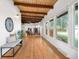 Inviting living room boasting wood floors, exposed beam ceiling, fireplace, and large windows offering ample natural light at 5471 S Sherman St, Littleton, CO 80121