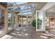 Sunroom with brick floors, glass ceiling, and views of the backyard patio and landscaping at 5471 S Sherman St, Littleton, CO 80121