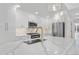 Bright kitchen with white cabinetry, quartz countertops, stainless steel appliances, and pendant lights at 1308 Snowberry Ln # 304, Louisville, CO 80027