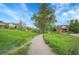 Take a leisurely stroll on the community walking path with scenic views of grassy fields and homes at 1308 Snowberry Ln # 304, Louisville, CO 80027