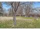 A spacious backyard with grass, trees, and wood fencing around the perimeter at 3693 E Costilla Ave, Centennial, CO 80122