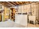 Unfinished basement laundry area with washer, dryer, utility sink, and exposed beams at 3693 E Costilla Ave, Centennial, CO 80122