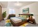 Cozy bedroom featuring stylish mid-century furniture, colorful accents, and soft carpet at 3693 E Costilla Ave, Centennial, CO 80122