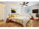 Bright bedroom features hardwood floors, a ceiling fan, and a large window for natural light at 3693 E Costilla Ave, Centennial, CO 80122