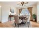 Bright dining room with hardwood floors, chandelier, and a large window with curtains at 3693 E Costilla Ave, Centennial, CO 80122