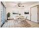 Bright dining area features a round table, modern chairs, and sliding glass doors for natural light at 3693 E Costilla Ave, Centennial, CO 80122