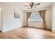 Well-lit dining room featuring hardwood floors, large windows with curtains, and ceiling fan at 3693 E Costilla Ave, Centennial, CO 80122