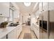 Eat-in kitchen features white cabinets, stainless steel appliances, and ample counter space at 3693 E Costilla Ave, Centennial, CO 80122
