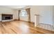 Inviting living room with hardwood floors, brick fireplace and bright window with curtains at 3693 E Costilla Ave, Centennial, CO 80122