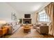 Inviting living room featuring a brick fireplace, hardwood floors, and bright natural light at 3693 E Costilla Ave, Centennial, CO 80122