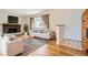 Cozy living room featuring a brick fireplace, hardwood floors, and a large window with natural light at 3693 E Costilla Ave, Centennial, CO 80122