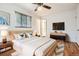 Light-filled main bedroom with hardwood floors, ceiling fan and modern decor at 3693 E Costilla Ave, Centennial, CO 80122