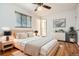 Comfortable bedroom with hardwood floors, neutral decor, and ensuite access, offering a relaxing retreat at 3693 E Costilla Ave, Centennial, CO 80122
