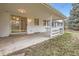 A covered patio with sliding glass door, attached to white brick exterior at 3693 E Costilla Ave, Centennial, CO 80122