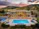 Expansive backyard featuring a sparkling pool, stone patio, and scenic mountain views, perfect for outdoor entertaining at 6729 Bear Point Trl, Golden, CO 80403