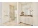 Bathroom featuring a spacious walk-in shower, vanity with a mirror, and tile floors at 6729 Bear Point Trl, Golden, CO 80403