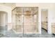 Large walk-in shower featuring designer tile and brass hardware in a luxurious bathroom at 6729 Bear Point Trl, Golden, CO 80403