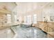 Spacious bathroom featuring a soaking tub, marble floors, and a glass shower at 6729 Bear Point Trl, Golden, CO 80403