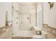 Beautiful bathroom featuring a glass-enclosed shower with multiple shower heads and tiled walls at 6729 Bear Point Trl, Golden, CO 80403