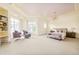 Large primary bedroom featuring a pink accent ceiling, sitting area, and ample natural light at 6729 Bear Point Trl, Golden, CO 80403