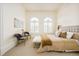 Inviting bedroom with natural light, two chairs, and a comfortable bed at 6729 Bear Point Trl, Golden, CO 80403
