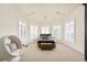Bright bedroom with an egg chair, carpet, and many windows at 6729 Bear Point Trl, Golden, CO 80403