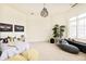 Bright bedroom with patterned throw pillows, trendy lighting, and plantation shutters at 6729 Bear Point Trl, Golden, CO 80403