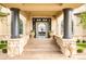 Grand entrance featuring stone columns, detailed stonework, and elegant double doors leading into a luxurious home at 6729 Bear Point Trl, Golden, CO 80403