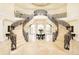 Elegant grand foyer with a dual staircase, wrought iron railings, high ceilings and marble floors at 6729 Bear Point Trl, Golden, CO 80403