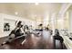 Home gym equipped with modern exercise machines and mirrored walls at 6729 Bear Point Trl, Golden, CO 80403