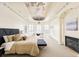 Luxurious main bedroom with a decorative ceiling, fireplace, and ample natural light at 6729 Bear Point Trl, Golden, CO 80403