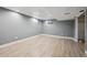 Spacious basement with laminate wood flooring and grey painted walls at 8397 Chase Dr, Arvada, CO 80003